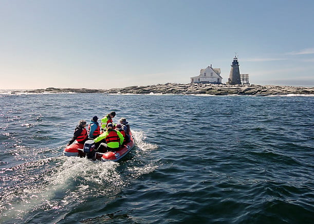 Students use a rigid hull inflatable to travel from College of the Atlantic's MV Osprey to the COA Edward McC. Blair Marine Research Station on Mount Desert Rock. The treeless island, 25 miles out to sea, is owned by the College and is used for students and faculty research into marine mammals and seabirds.