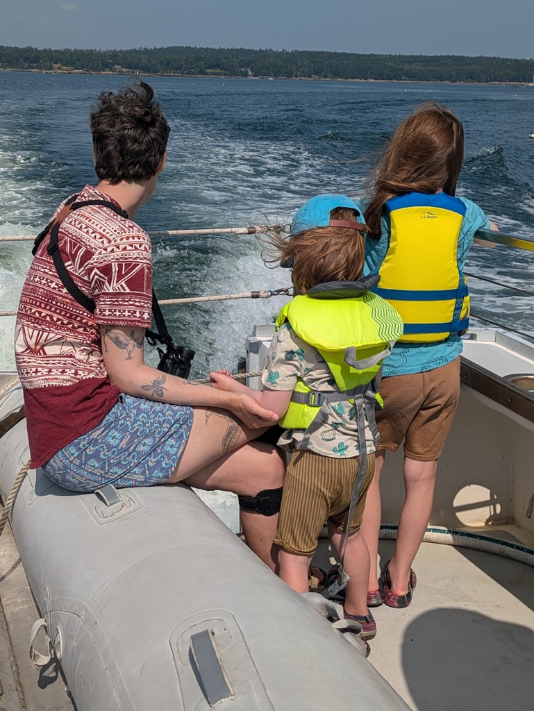 alumni watch the water from the boat
