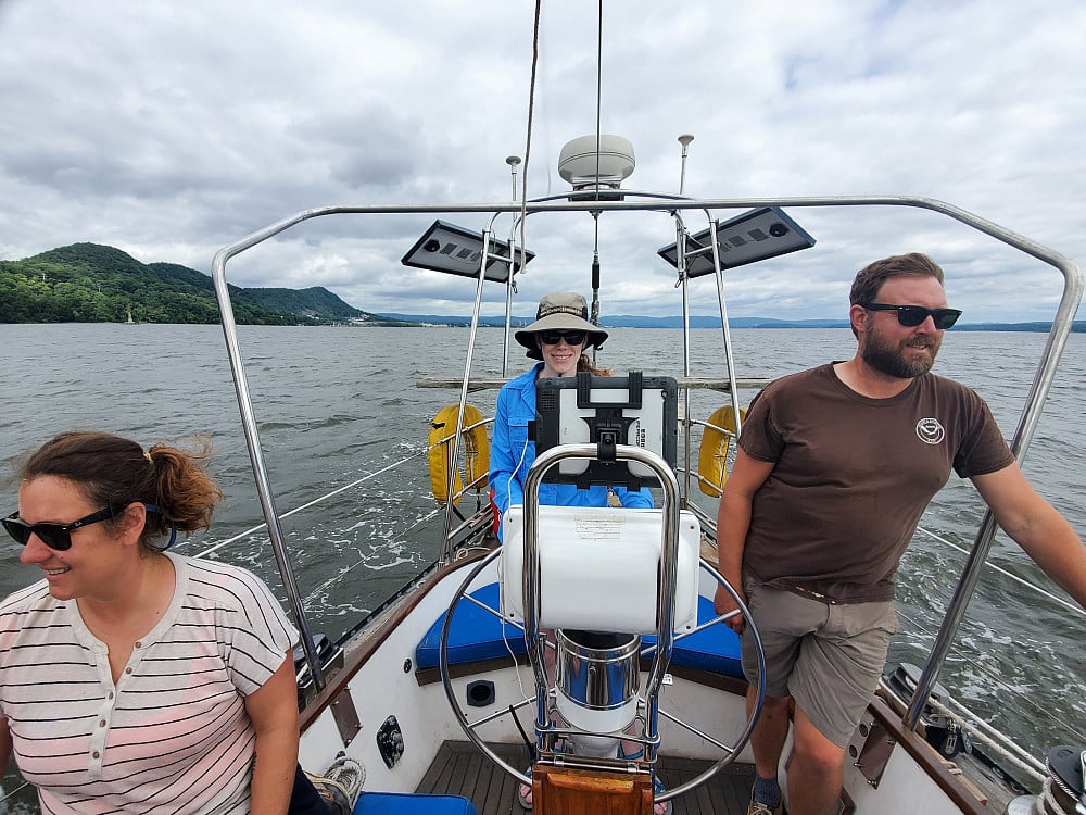 Crew members, from left, Tanya Lubansky, Lindsey Jones ’18, and Chris Tremblay ’03 pilot River Gu...