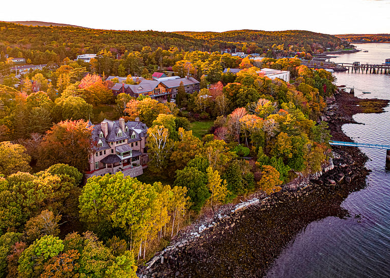 Autumn landscape with waterfront buildings.