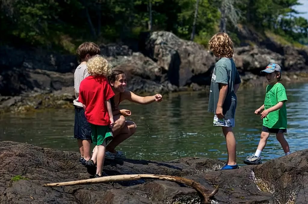 Kids playing near the water.