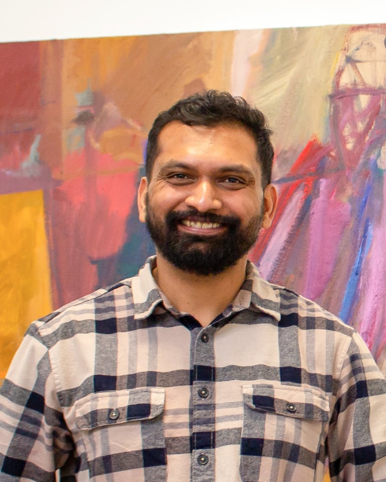 neeraj headshot in front of a painting