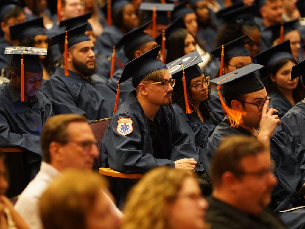 Paramedic and EMS program graduates celebrating at a CAHE commencement ceremony.