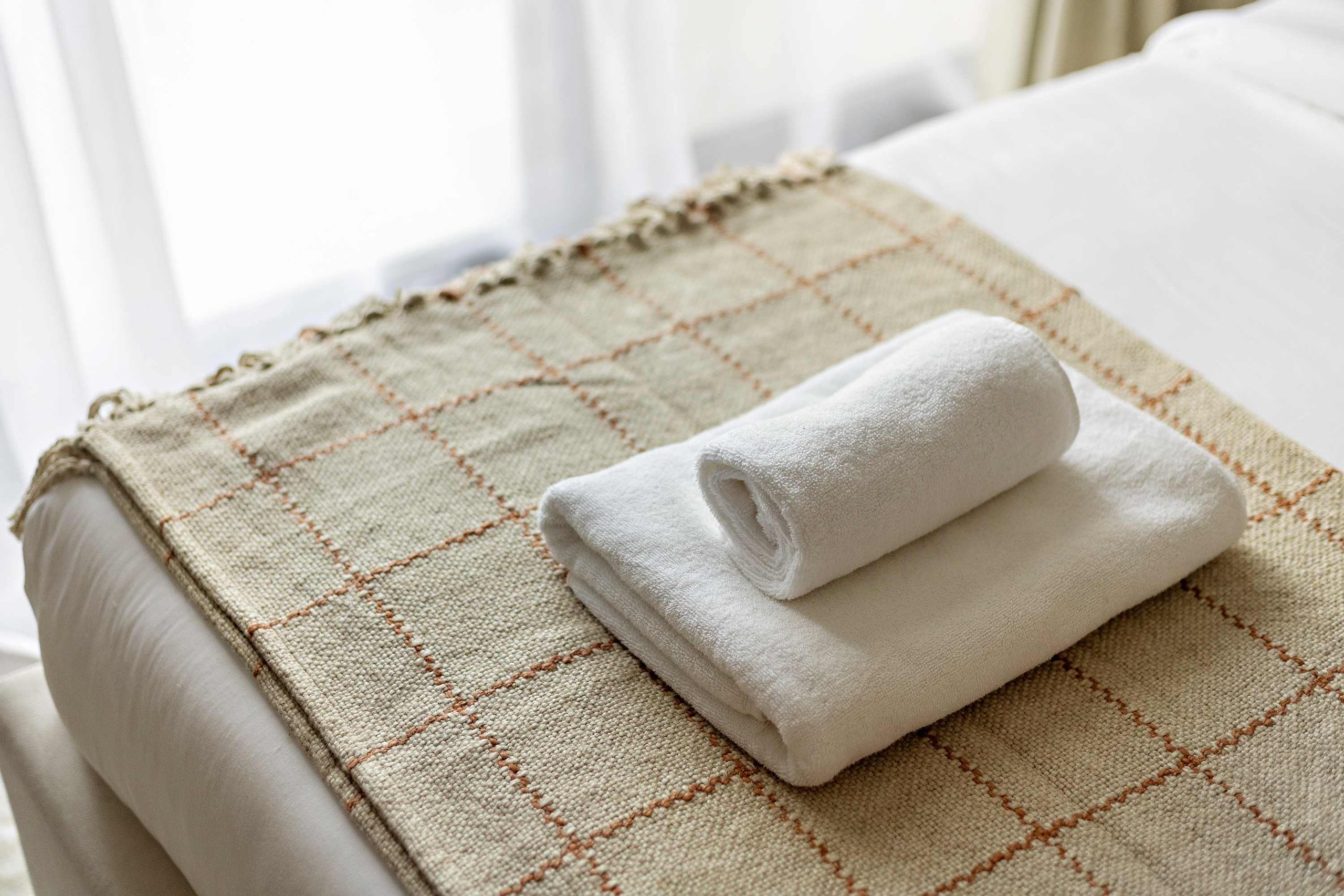 Freshly made bed with hotel-grade linen