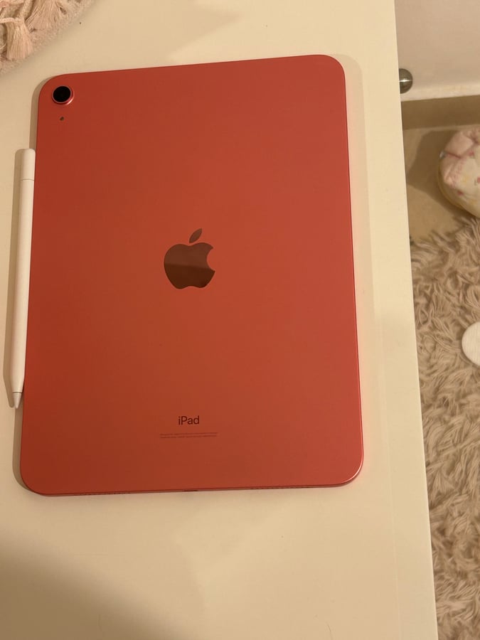 Apple iPad 10th gen (coral red) with Apple Pencil. 