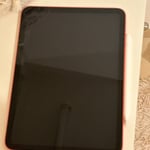 Apple iPad 10th gen (coral red) with Apple Pencil. 