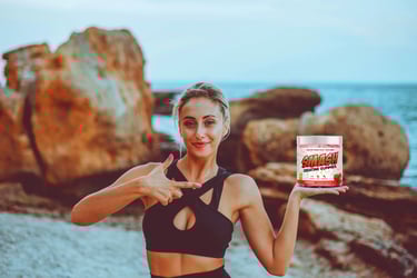 Person holding a supplement container on a rocky beach background.