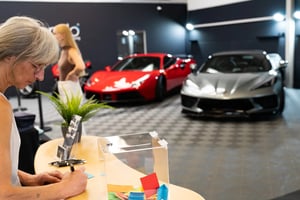 Unser Unternehmen 1 a woman signing a car in a showroom