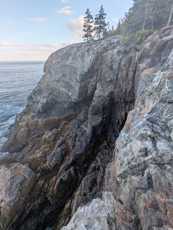 Image with caption 'Somewhere down there is the cave.'