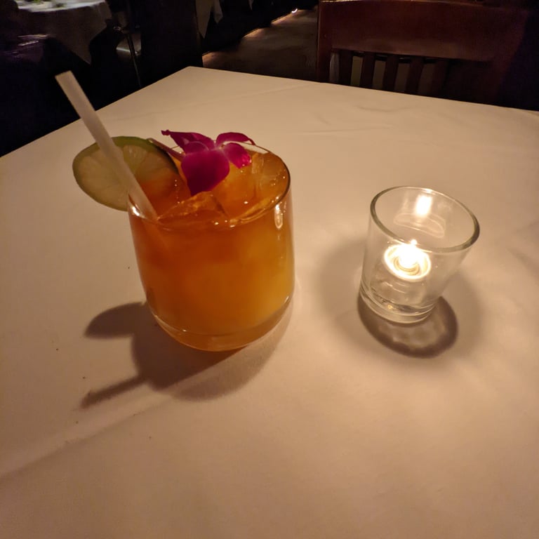 Image with caption 'A Mai Tai, with a nice flower on top.'
