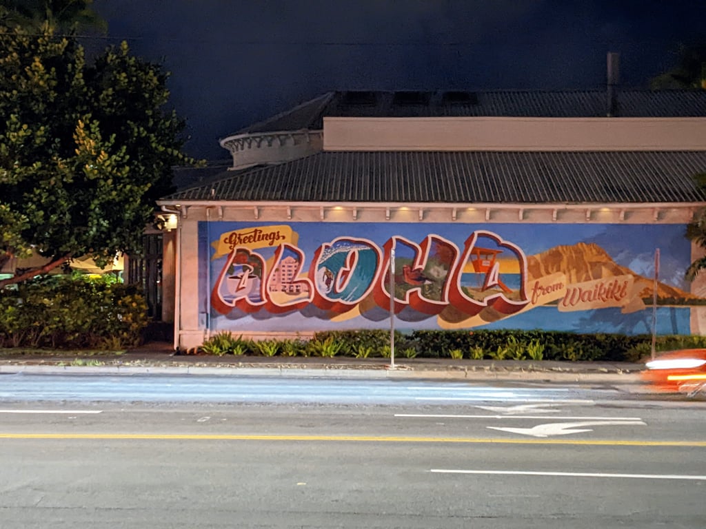 Image with caption 'A nice mural with the text: 'Greetings, ALOHA from Waikiki.' I might use this as a makeshift postcard...'