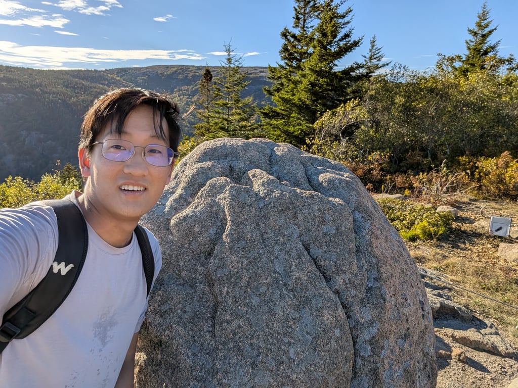 Image with caption 'Right when you reach the summit of South Bubble, there's a little rock sitting by itself to the side. We decided to take some pictures (mostly in jest) when a fellow hiker said that the real bubble rock is further on and much bigger. But the bubble's smaller son should also get a callout.'