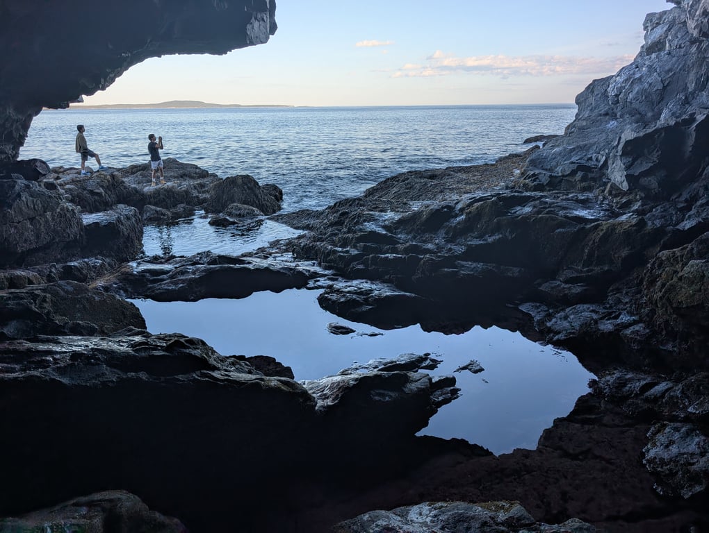 Image with caption 'The hike here is quite easy actually, both short and paved except for the last stretch. The tricky part is carefully (both for personal safety and to protect the wildlife) working down the slightly wet rocks to get the right view from inside the cave.'