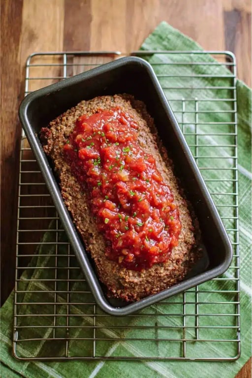 Keto meatloaf in pan topped with salsa on cooling rack