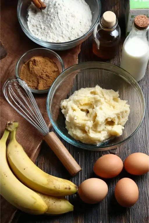 Ingredients for low carb banana bread including mashed banana, eggs, and flour