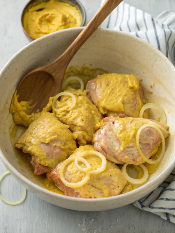 Combining chicken, onions, and sauce for the final simmer in the Persian chicken recipe