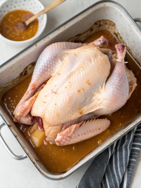 Fully cooked apple butter turkey resting before carving, with golden glazed skin