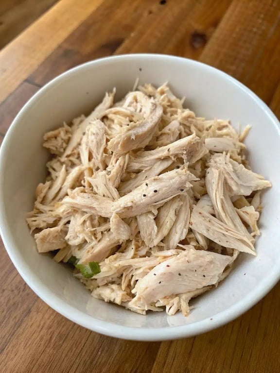 slow cooker shredded chicken served in a soft tortilla with fresh toppings like lettuce and tomato
