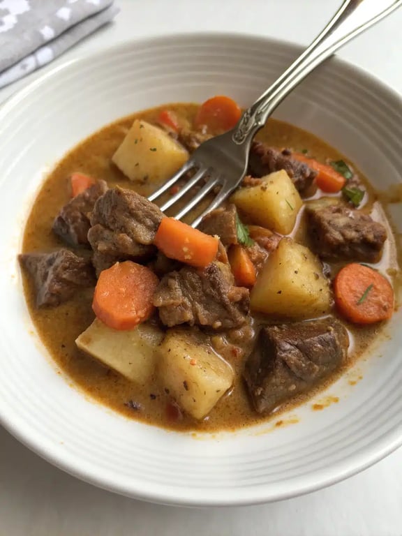 slow cooker Valentine's dinner beautifully plated in a bowl with crusty bread on the side