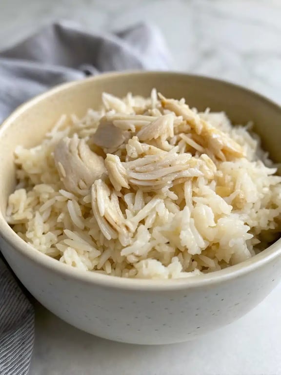 instant pot chicken rice plated with a side salad and bread