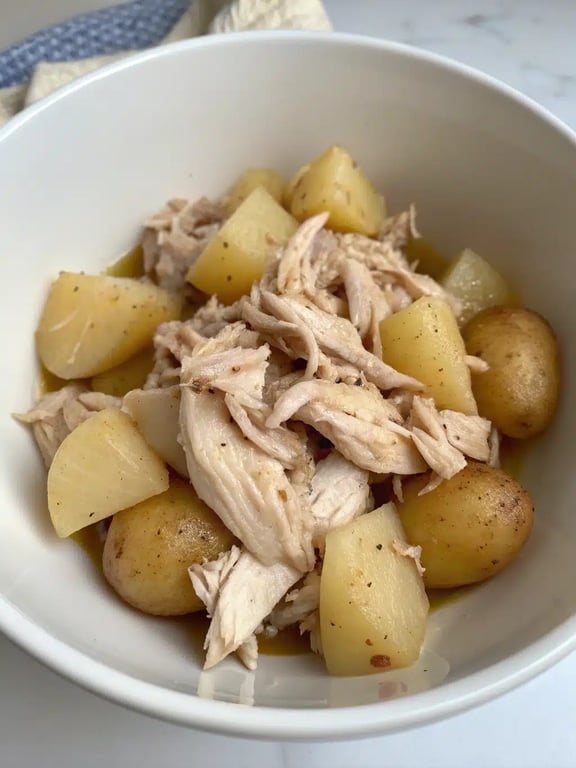 A beautifully plated serving of crockpot chicken potatoes with a side of green beans