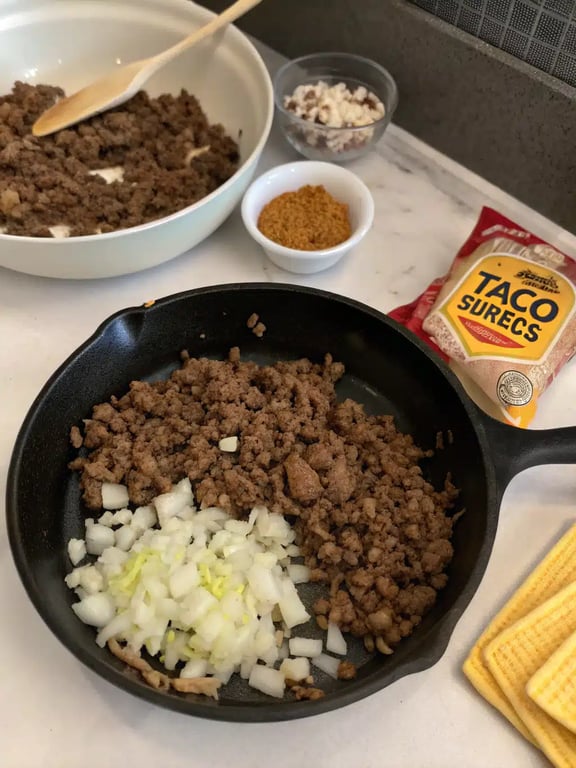 Step 2 for ground beef enchiladas — process in progress