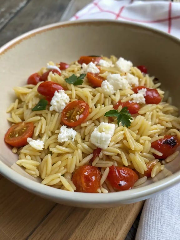 orzo dinner recipe beautifully plated with a side salad and lemon wedge