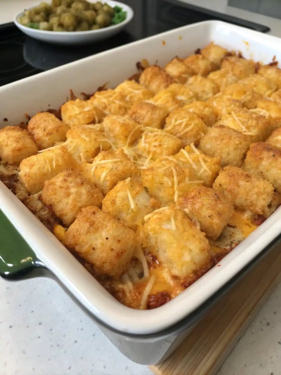 tater tot casserole served on a plate with a fresh green salad