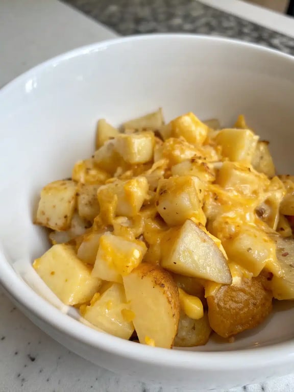 cheesy potato scramble plated with toast and fresh herbs