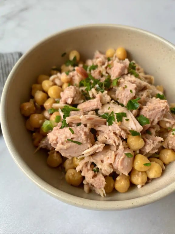tuna chickpea salad served in a lettuce wrap with fresh vegetables on the side