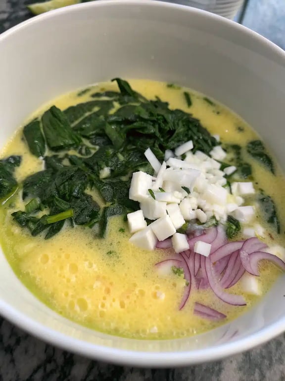 Step 4 for crustless spinach quiche — texture check