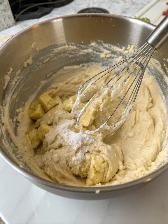 Frying banana donut holes in hot oil until golden brown
