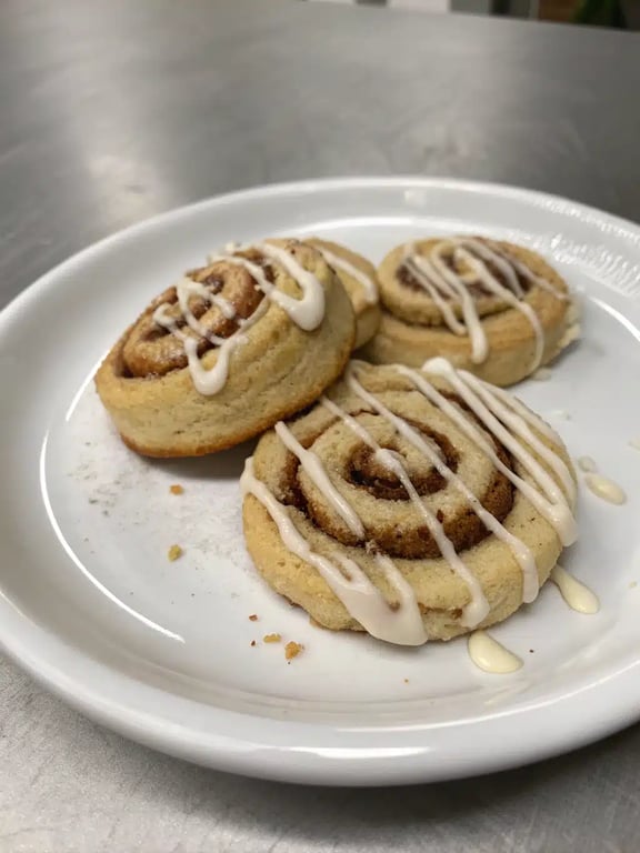 cinnamon roll cookies beautifully arranged on a wooden board with coffee