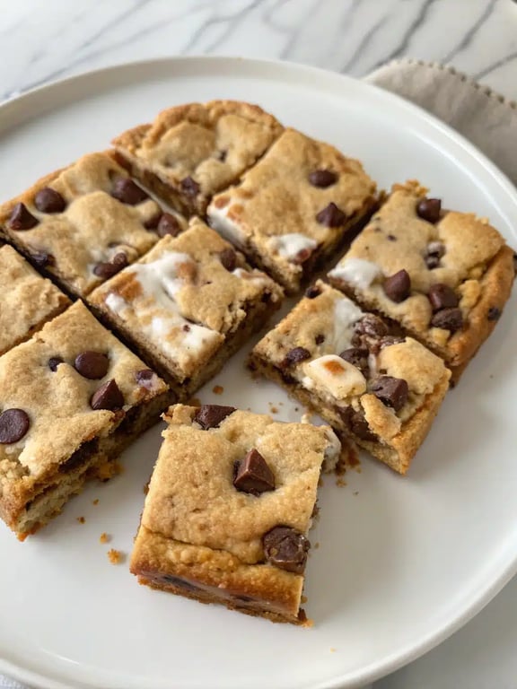 s'mores cookie bars served with ice cream and chocolate drizzle