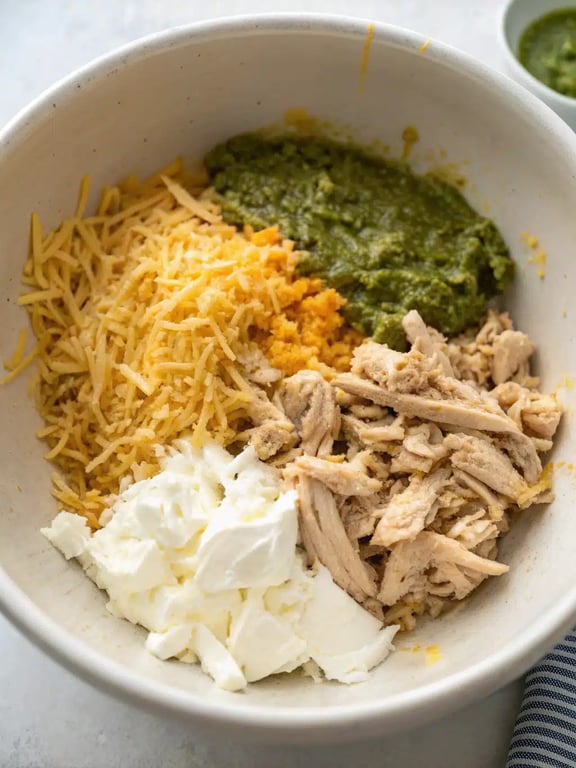 Softening corn tortillas for baked chicken taquitos in a skillet