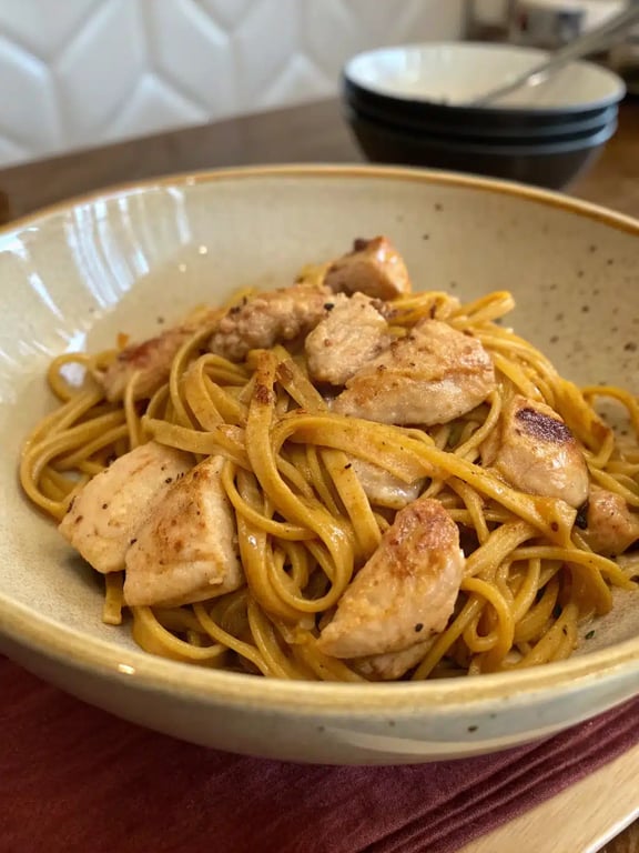 Chicken buttered noodles plated with a side salad and bread
