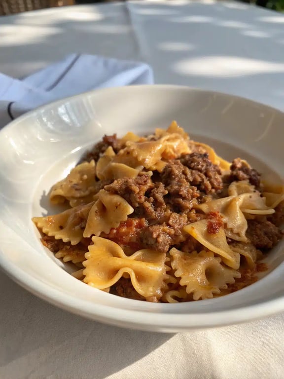 bowtie pasta beef beautifully plated with a side salad