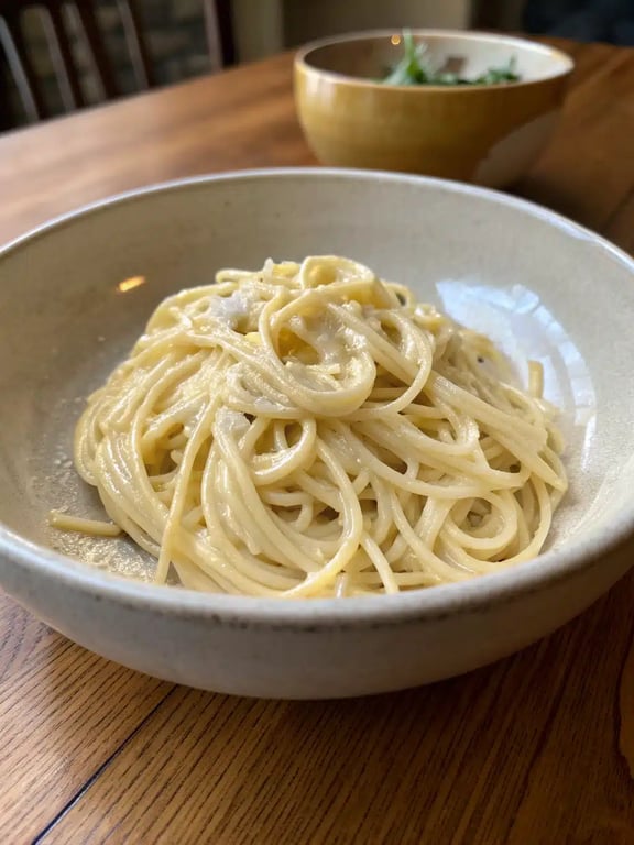 creamy garlic spaghetti plated elegantly with a side salad and garlic bread