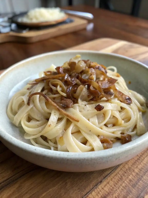 French onion pasta recipe plated elegantly with a side salad and garnish
