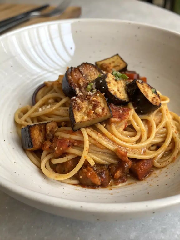 roasted eggplant pasta beautifully plated with a side salad