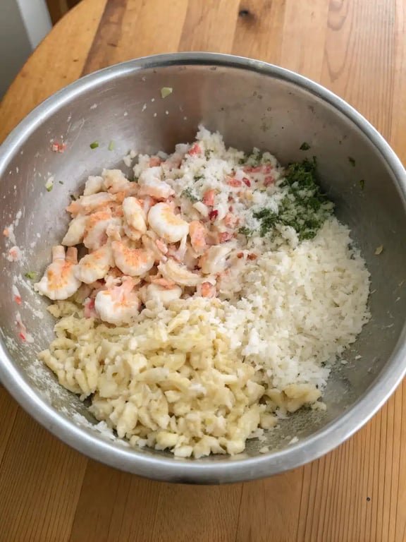 Filling pasta shells with the crab and shrimp mixture for seafood stuffed shells