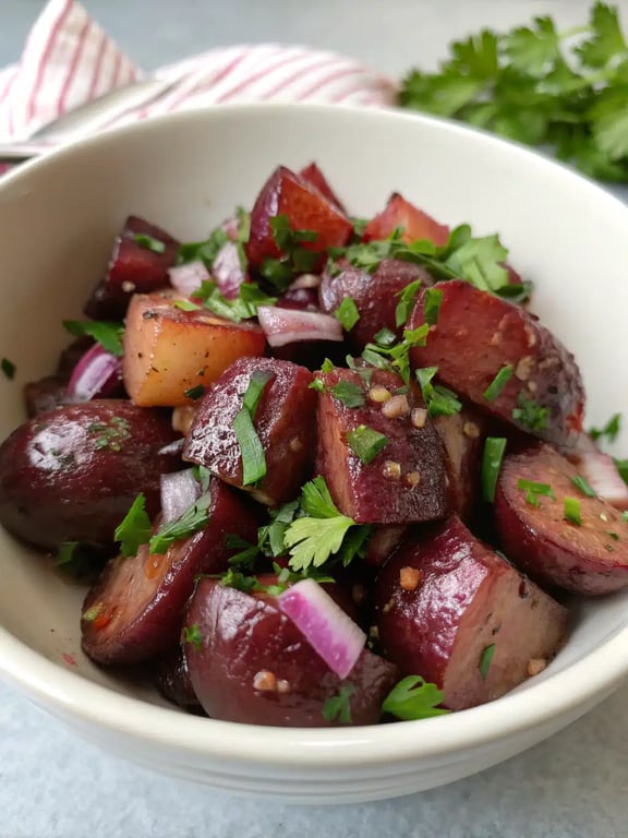 balsamic potato salad beautifully plated with grilled chicken and fresh herbs