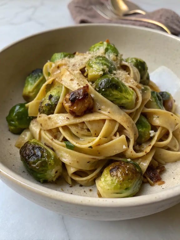 Brussels sprouts pasta beautifully plated with a side salad