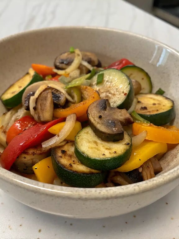 sautéed vegetables recipe plated alongside grilled chicken and rice