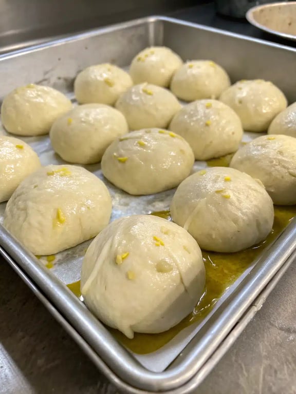 A final platter of golden brown garlic bread rolls, fresh from the oven