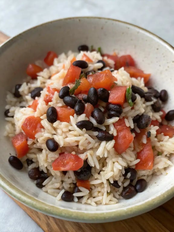 spanish rice beans served in a bowl with lime and avocado