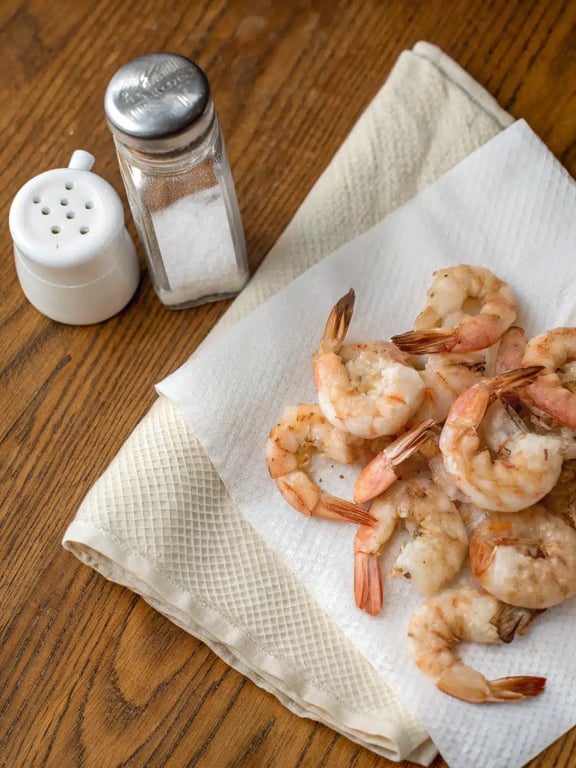 Step 2 for lemon feta shrimp — shrimp cooking in a hot skillet