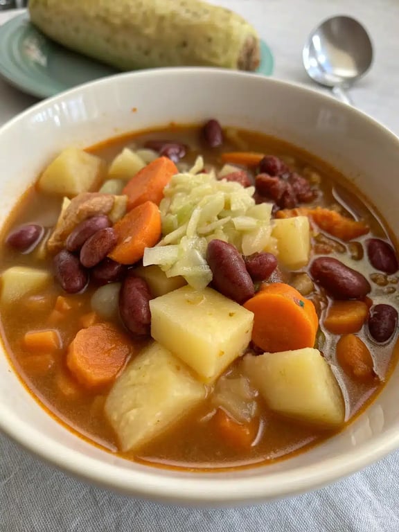 Portuguese bean soup recipe served in a rustic bowl with crusty bread on the side