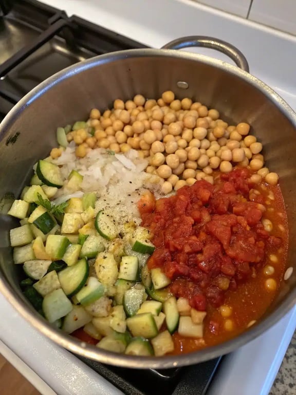 Simmering vegan tomato stew Step 4 for vegan tomato stew — checking the tenderness of zucchini in the simmering pot.