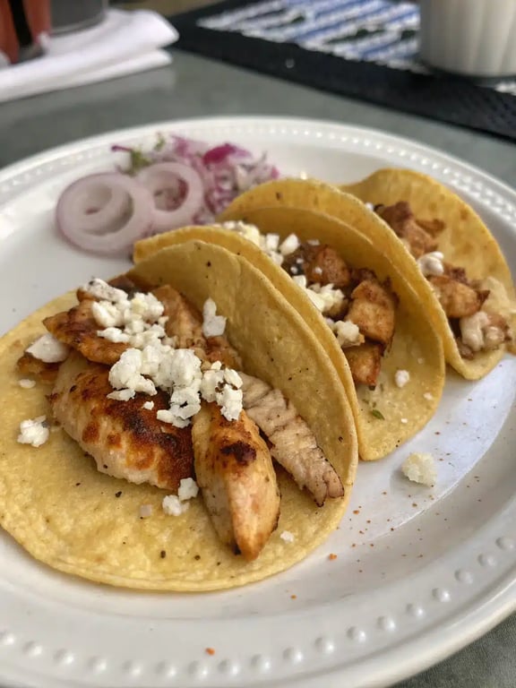 Chicken street tacos plated with sides for a complete meal
